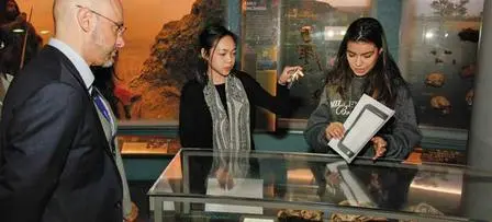 Students showing the program to a visitor